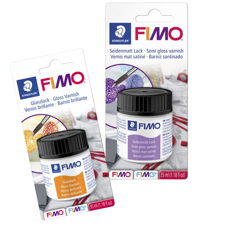 May include: Two bottles of FIMO varnish, one gloss and one semi-gloss, with black caps and white labels. The labels display the product name in multiple languages, including English, German, and French. Each bottle contains 35 ml (1.18 fl oz) of varnish.