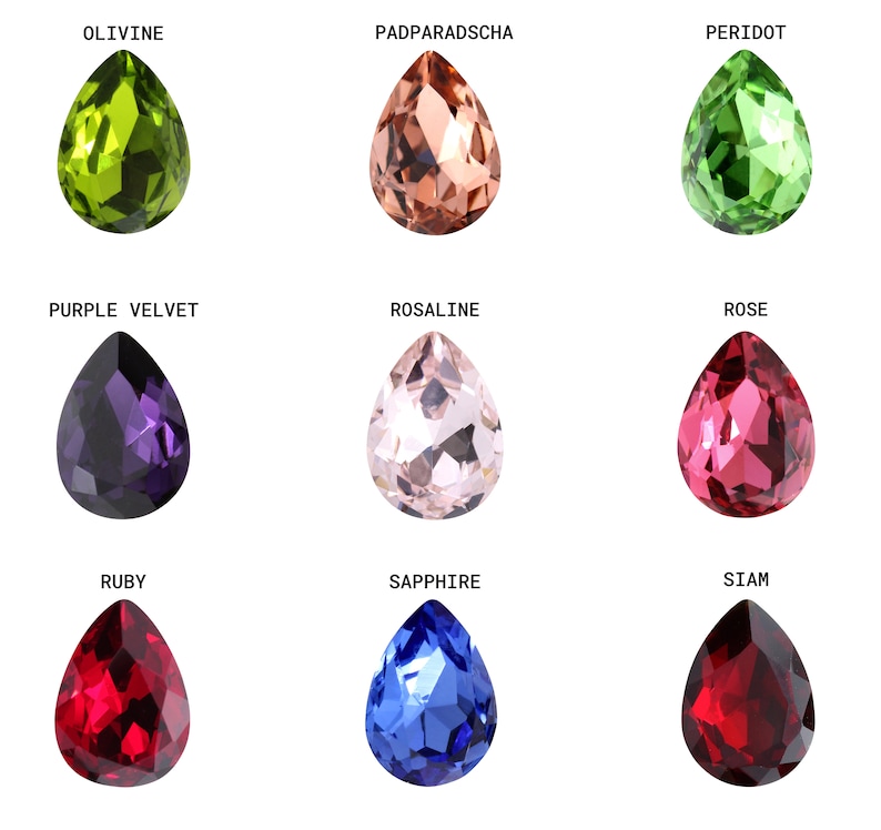 May include: Nine teardrop-shaped gemstones in various colors, including green, brown, red, blue, and purple. The gemstones are labeled with their names: Olivine, Padparadscha, Peridot, Purple Velvet, Rosaline, Rose, Ruby, Sapphire, and Siam.