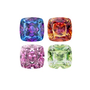 May include: Four square-shaped gemstones in different colors: blue, red, pink, and green. The gemstones are faceted and have a shiny, reflective surface.