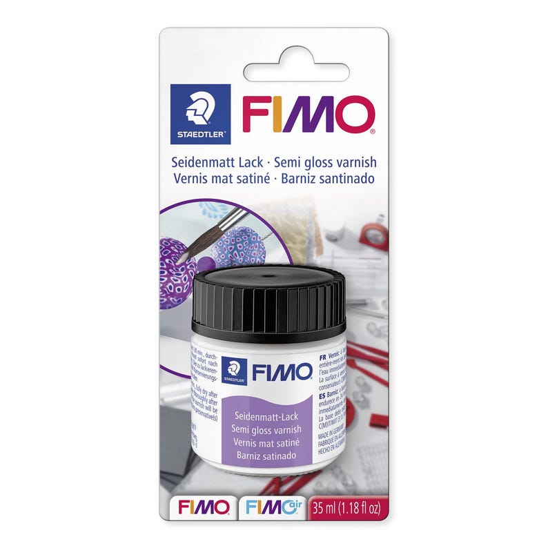 May include: A bottle of FIMO semi-gloss varnish with a black cap, displayed on a white and gray product card. The label includes the text "Seidenmatt Lack - Semi gloss varnish" and "35 ml (1.18 fl oz)". The Staedtler and FIMO logos are visible.
