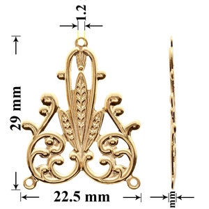 May include: Gold-toned metal pendant with a decorative design featuring a central floral motif and intricate scrollwork. The pendant measures 29 mm in height, 22.5 mm in width, and 1.2 mm in thickness.