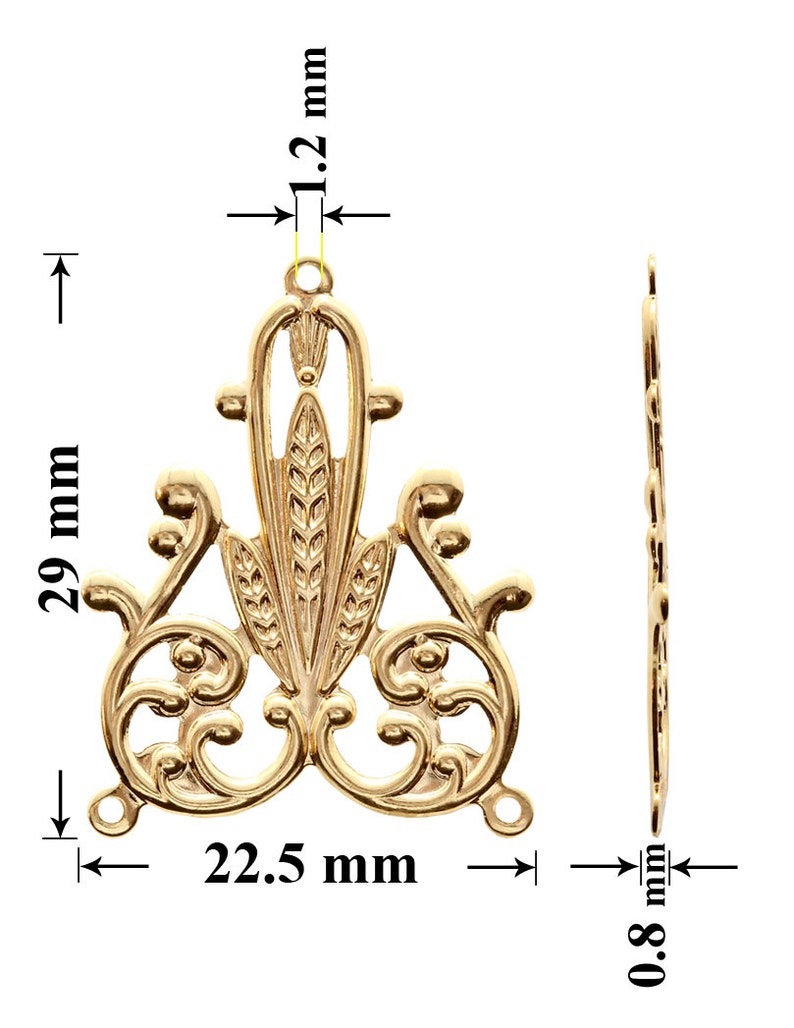 May include: Gold-toned metal pendant with a decorative design featuring a central floral motif and intricate scrollwork. The pendant measures 29 mm in height, 22.5 mm in width, and 1.2 mm in thickness.