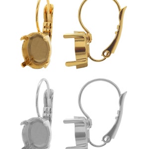 May include: Two pairs of earring settings, one gold and one silver. Each setting has a round bezel for a stone and a lever back closure.