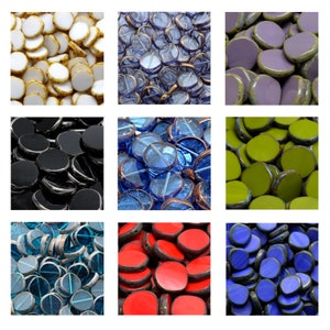 May include: Assortment of round glass beads in various colors, including white, blue, black, green, red, and purple. The beads are arranged in a grid pattern.