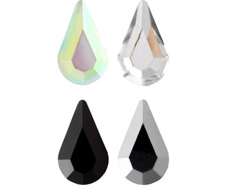 May include: Four teardrop-shaped rhinestones in different colors: iridescent, clear, black, and silver.
