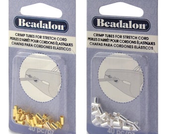 May include: Two packages of gold and silver crimp tubes for stretch cord. Each package contains 40 pieces and has the text "Beadalon" and "Crimp Tubes for Stretch Cord" printed on it.