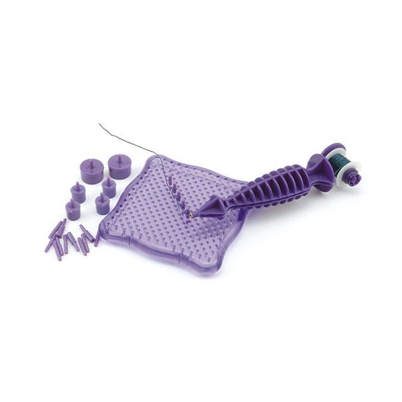 May include: Purple plastic beading tool with a square base, a needle, and a spool of thread. The tool is used to create beaded jewelry.