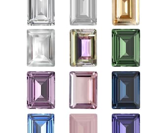 May include: Twelve emerald-cut gemstones in various colours, including clear, gold, green, purple, pink, and blue. The gemstones are arranged in three rows of four.