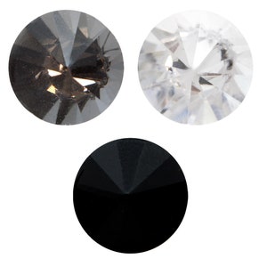 Peut inclure: Trois gemmes rondes en verre facetté en noir, gris et transparent.