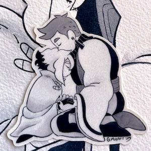 May include: Black and white sticker featuring two figures embracing. One figure is kneeling, head resting on the other's head. The sticker has a hand-drawn style with the artist's signature, G. KRAFT '23, in the bottom right corner. The background is a simple, textured white.