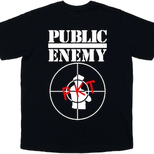 May include: Black t-shirt with white text that reads "PUBLIC ENEMY" and a white target symbol with a red "PKT" inside.