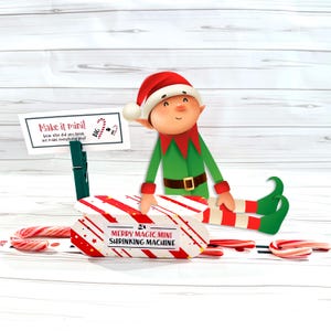 May include: A festive Christmas-themed illustration featuring an elf in a green and red outfit, a red and white striped box labeled "Merry Magic Mini Shrinking Machine," and candy canes. A sign reads "Make it mini!" with text.