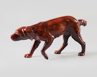 A large vintage statue of a hunting dog