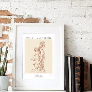 May include: A framed print of a line drawing of the sculpture "Apollo and Daphne" by Gian Lorenzo Bernini. The print is on a cream background with the title and artist's name in brown text.