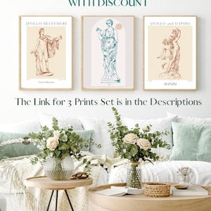 May include: Three framed prints of classical sculptures. The prints are in a living room setting with a white couch, a wooden coffee table, and a side table with a vase of flowers.