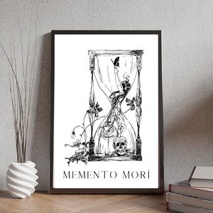 May include: Black and white illustration of an hourglass with a skull at the bottom and a butterfly flying above. The hourglass is surrounded by vines and flowers. The text "MEMENTO MORI" is printed below the hourglass.