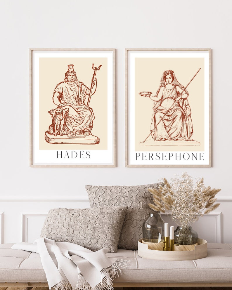 May include: Two framed illustrations of Greek gods, Hades and Persephone, in a red-brown color scheme. The illustrations are set against a cream background and feature detailed line drawings of the figures.