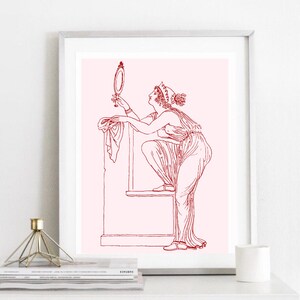 May include: A red line drawing of a woman in a long dress looking at a hand mirror. The woman is standing on a platform with a draped cloth. The background is a light pink color.