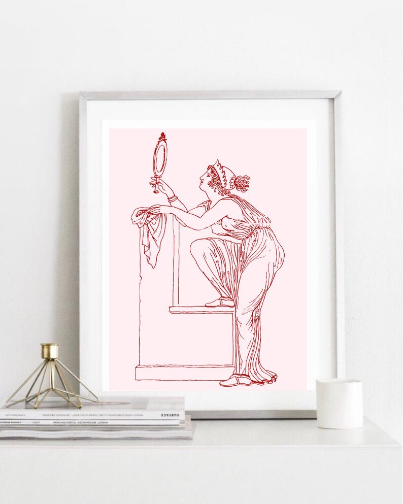 May include: A red line drawing of a woman in a long dress looking at a hand mirror. The woman is standing on a platform with a draped cloth. The background is a light pink color.