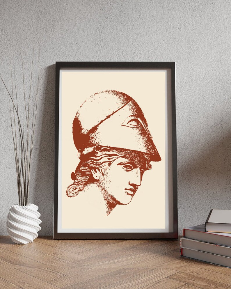 May include: A brown and white print of a woman's head wearing a helmet. The print is in a black frame.