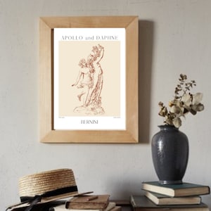 May include: A framed print of a line drawing of the sculpture "Apollo and Daphne" by Gian Lorenzo Bernini. The print is on a cream background with the title and artist's name in brown text.