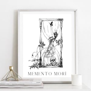 May include: Black and white illustration of an hourglass with a skull and a butterfly inside. The hourglass is surrounded by vines and flowers. The text "Memento Mori" is written below the hourglass.
