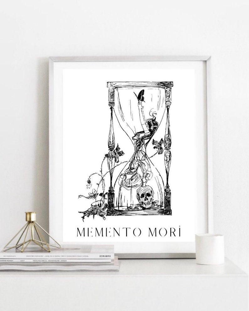 May include: Black and white illustration of an hourglass with a skull and a butterfly inside. The hourglass is surrounded by vines and flowers. The text "Memento Mori" is written below the hourglass.