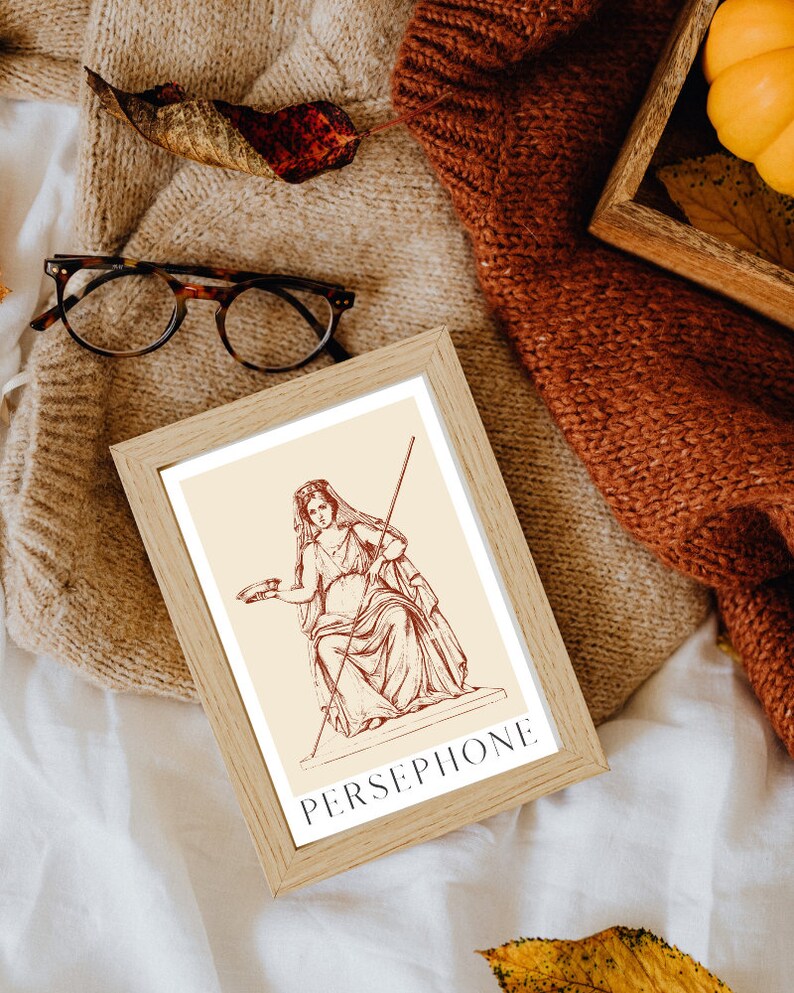 May include: A framed print of a line drawing of Persephone, the Greek goddess of spring, in a seated pose. The print is on a cream background with the word "PERSEPHONE" in red lettering at the bottom.
