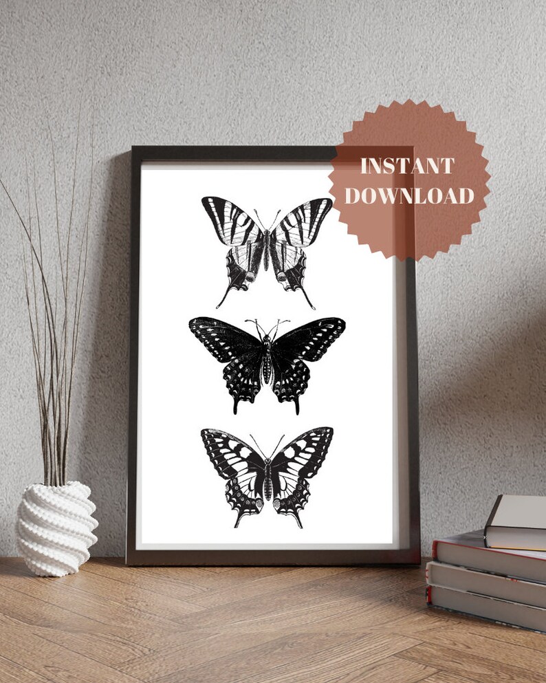 May include: A printable art print featuring three black and white butterfly illustrations. The butterflies are arranged vertically, with the top butterfly having striped wings and the bottom two butterflies having solid wings.