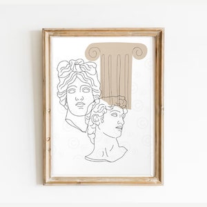 May include: Line art print of two classical busts with a brown column behind them. The print is framed in a light wood frame.