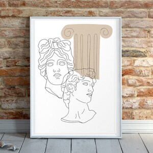 May include: Line art print of two classical busts with a brown column behind them. The print is framed in a white frame.