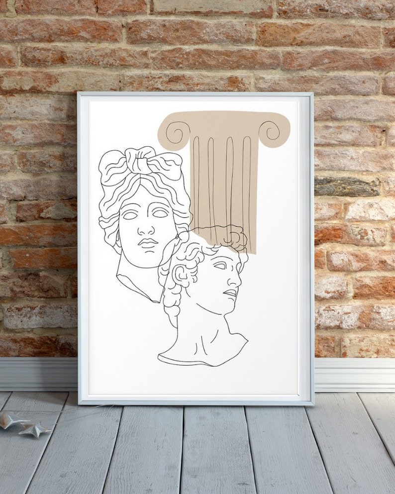 May include: Line art print of two classical busts with a brown column behind them. The print is framed in a white frame.