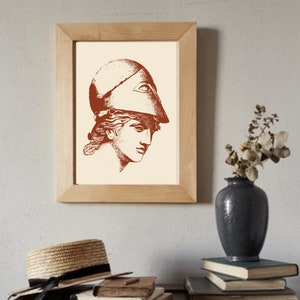 May include: A framed print of a line drawing of a woman wearing a helmet. The drawing is in shades of brown on a cream background.