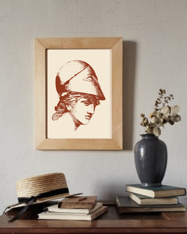 May include: A framed print of a line drawing of a woman wearing a helmet. The drawing is in shades of brown on a cream background.