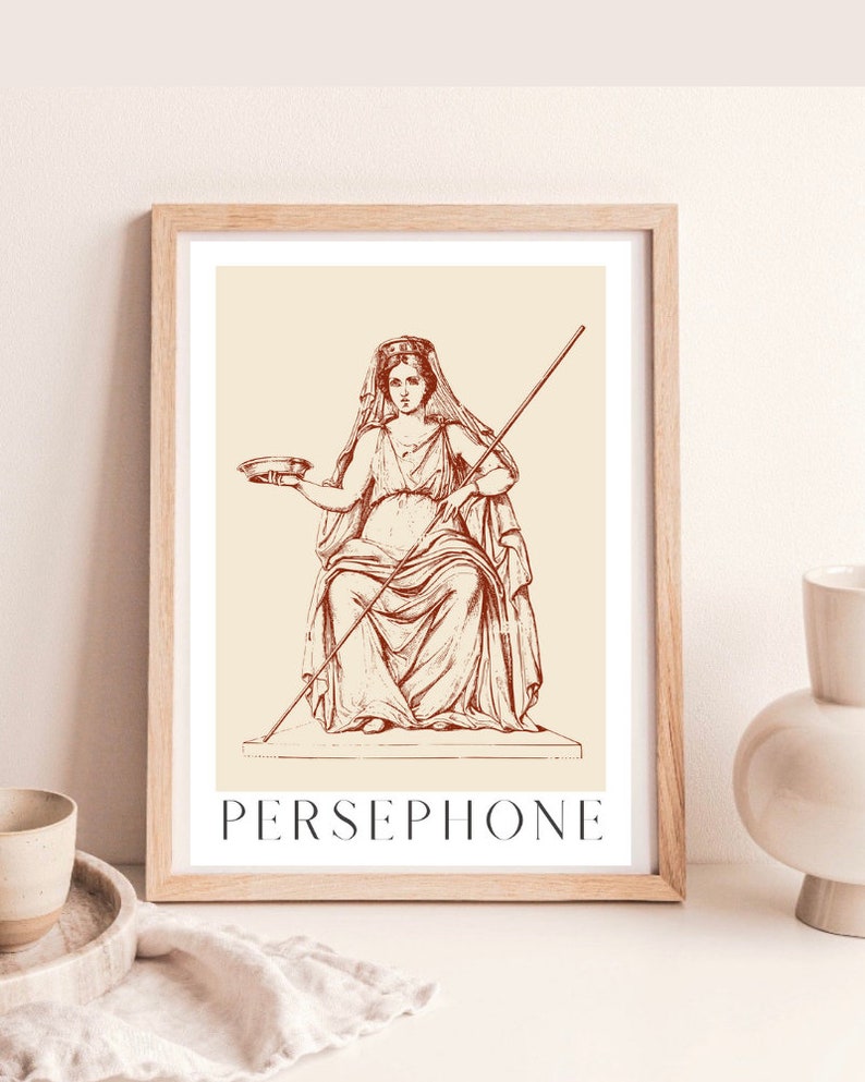 May include: A vintage illustration of Persephone, the Greek goddess of spring, in a red-brown color scheme. She is depicted wearing a crown and holding a bowl and a staff. The image is framed in a light wood frame.