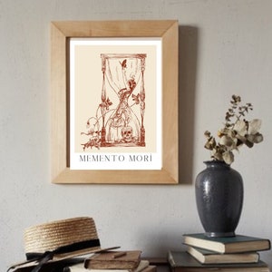 May include: A framed print featuring a brown hourglass with a skull at the base and a butterfly flying above. The print includes the text "MEMENTO MORI" at the bottom.