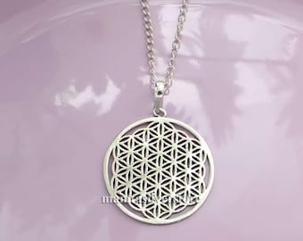 May include: A silver necklace with a round pendant featuring a detailed flower of life design.