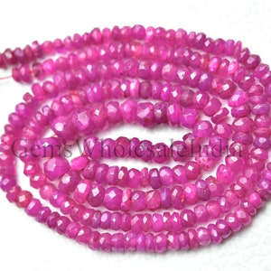 May include: A strand of pink faceted gemstone beads. The beads are small and have a slightly irregular shape. The strand is approximately 18 inches long.