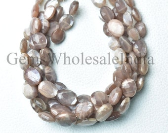 May include: A strand of light brown sunstone beads with a faceted oval shape. The beads are strung on a clear thread and are arranged in a circular pattern.