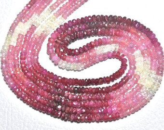 May include: Strands of faceted gemstone beads in shades of pink, red, and white. The beads are small and uniform in size, creating a gradient effect from light to dark. The beads are likely used for jewelry making.