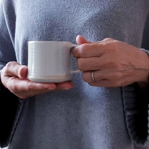 Coffee cup with handle in semi-matt white artisan ceramic. Modern, white, minimal coffee cup.