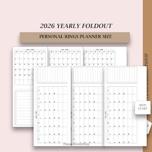 May include: A collection of undated 2026 yearly foldout planner inserts. The inserts are white with black text and include monthly calendars and lined pages. The text "2026 YEARLY FOLDOUT" and "PERSONAL RINGS PLANNER SIZE" are at the top.