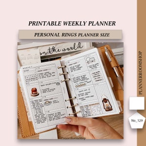 May include: A printable weekly planner in a personal size ring binder. The planner has a white background with black grid lines and handwritten text. The planner is open to a weekly spread with a to-do list, a daily schedule, and a notes section. The planner is decorated with stickers and drawings. The planner is labelled "Printable Weekly Planner" and "Personal Rings Planner Size".