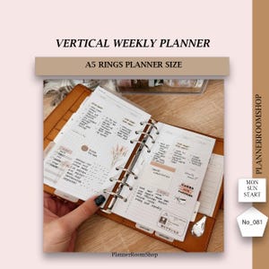 May include: Open A5 ring planner with a vertical weekly layout. The planner is open to a spread with handwritten notes, stickers, and a section labeled "CAKES AND PASTRIES." The cover is brown leather, and the text "VERTICAL WEEKLY PLANNER" is at the top.