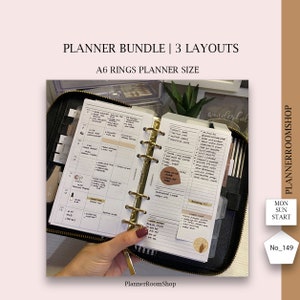 May include: A black A6 ring planner with gold rings. The planner is open to a weekly spread with a to-do list and a habit tracker. The planner is decorated with stickers and washi tape. The text "PlannerRoomShop" is visible on the bottom of the image.