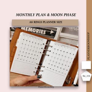 May include: An open A6 ring planner with tan leather covers showing monthly calendar pages for January and February 2023. The pages feature moon phase icons, grid layouts, and lined sections. Text includes MONTHLY PLAN & MOON PHASE and PLANNERROOMSHOP.