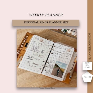May include: A weekly planner in a personal rings planner size. The planner is open to a weekly spread with a photo of a road in a field. The planner has a brown leather cover and is on a wooden surface. The planner is labeled "PlannerRoomShop" and "No. 186".