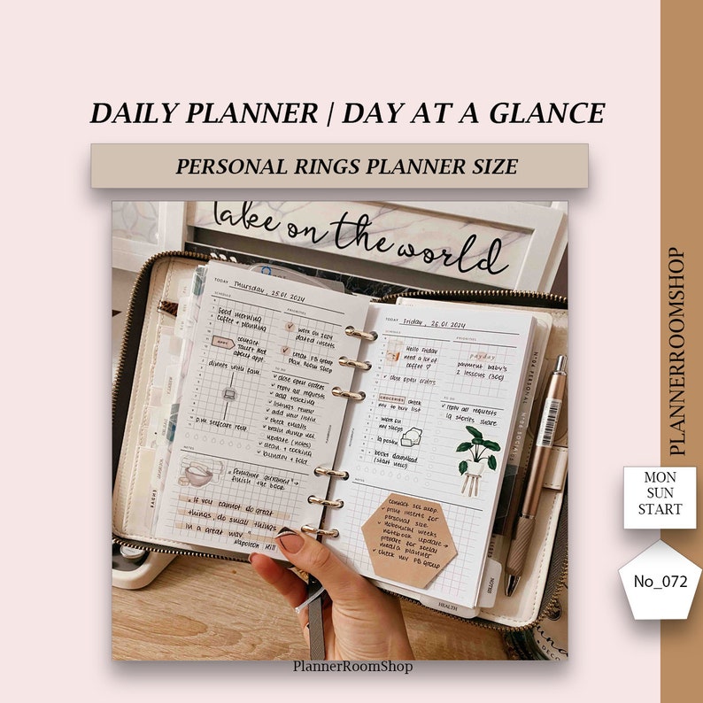 May include: A white personal planner with a black cover and gold rings. The planner is open to a daily spread with handwritten notes and stickers. The text "lake on the world" is written on the top of the page. The planner is labeled "PlannerRoomShop".