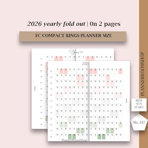 Op de afbeelding: Witte 2026 jaarlijkse uitvouwbare plannerpagina's met roze en groen gemarkeerde datums. De tekst op de pagina's luidt "2026" en "FC COMPACT RINGS PLANNER SIZE". De planner is gelabeld "PlannerRoomShop".
