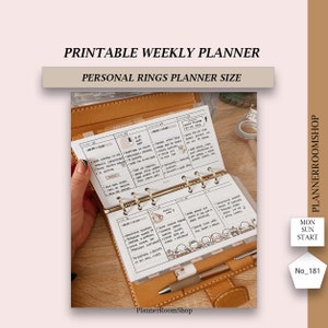 May include: A close-up of a brown leather personal planner with gold rings. The planner is open to a weekly spread with handwritten notes and a coffee cup illustration. The planner is labelled "Printable Weekly Planner" and "Personal Rings Planner Size".